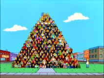 Homer gets ready to scale a giant human pyramid in a failed world record attempt that gets Springfield recognized for different reasons.