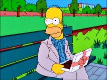 On a bench with a box of chocolates, Homer comes close to being arrested for impersonating a movie character in the opening to his clip show "Gump Roast."