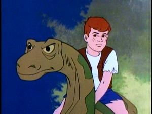 He looks like he's 15, he acts like he's 6. The over-explanatory Dino Boy makes a tough face atop his pet brontosaurus Bronty.