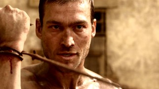 Spartacus (Andy Whitfield), the newest arrival at Batiatus' ludus, catches Doctore's whip on his wrist. So it begins...
