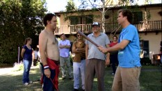 Director Adam McKay smiles at the sight of Will Ferrell beating a shirtless John C. Reilly (safely, with a rubber bat) in "The Making of Step Brothers."
