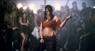 Much to the delight of everyone around her, Andie (Briana Evigan) does a crotch grab and air guitar move outside in the pouring rain.