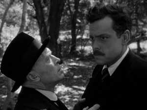 The mind of Professor Charles Rankin (Orson Welles, right) appears to be wandering as Konrad (Konstantin Shayne) warns him of trouble.