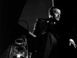Are you pondering what I'm pondering? Shrouded by darkness atop a church bell tower, Orson Welles strikes a Harry Lime-esque pose.
