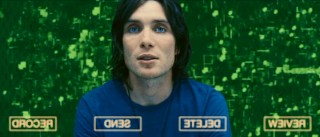 Robert Capa (Cillian Murphy) records a video message for his relatives back on Earth.