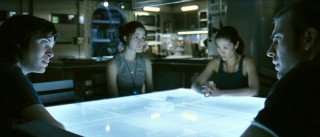 Capa and Mace (Chris Evans) stare each other down, while the two women in between them stay out of it.