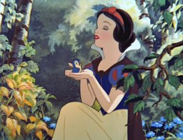 Snow White holds a blue bird in her hands.