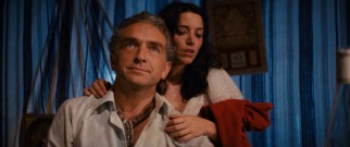 Marion (Karen Allen) clings to Belloq (Paul Freeman), a nemesis keeping her safe.