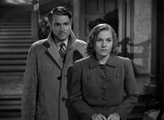 Drenched from the rain, the de Winters (Laurence Olivier, Joan Fontaine) make their first entrance to Manderley as newlyweds.