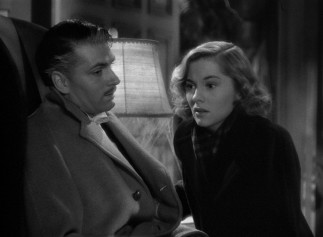 At last, Maxim (Laurence Olivier) shares his dark secret with Mrs. de Winter (Joan Fontaine).