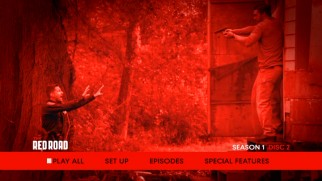 Disc 2's main menu drenches a scene from "The Red Road" in the titular hue.
