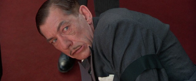 Richard III (Ian McKellen) shows off his evil eye when an aid tries to pick him off the ground.
