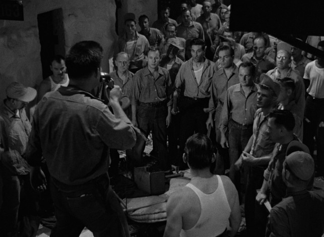 Dunn uses words to rally and unify the rioting convicts of Cell Block 11.