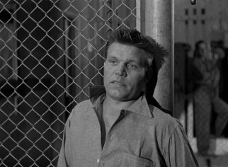 Veteran convict Dunn (Neville Brand) speaks on behalf of the rioting prisoners.