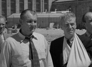 Warden Reynolds (Emile Meyer) and the wounded Commissioner Haskell (Frank Faylen) don't see eye to eye on agreeing to the rioters' demands.