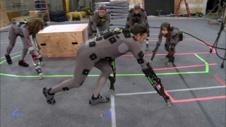 Assorted ape performers walk around on all fours with help from tiny crutches in "A New Generation of Apes."