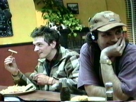 Director Robert Rodriguez dons headphones, a University of Texas hat, and a smile, sitting next to John Hawkes rehearsing his memorable French fry philosophy scene.