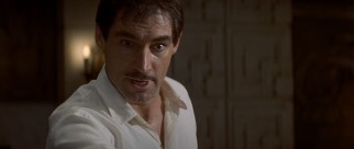Timothy Dalton sports a mustache as movie star Neville Sinclair, who quotes his films in his seduction of starlets.