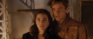 Jenny (Jennifer Connelly) and Cliff (Billy Campbell) face danger inside a zeppelin in the film's climax.