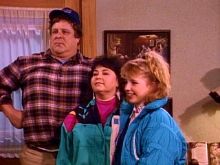 John Goodman, Roseanne Barr, and Alicia Goranson horse around in the Bloopers reel.