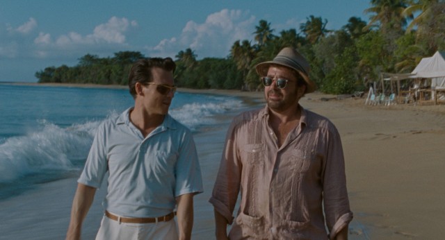 Paul Kemp (Johnny Depp) and Bob Sala (Michael Rispoli) go for a sunset walk on the shore of an uninhabited Puerto Rican island being developed.
