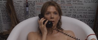Deirdre Burroughs (Annette Bening) takes a phone call in the bathtub surrounded by a sea of hand-written words.