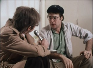 Brian Thigh (Dan Aykroyd) endures insults and coughs in this extended interview Easter egg.