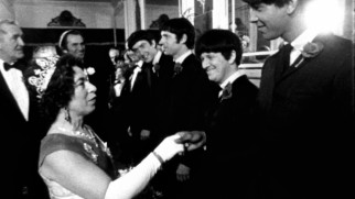 The Queen of England (Jeannette Charles) meets the Rutles in a cramped scene from "The Rutles in All You Need Is Cash."