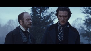 Doctor Clements (Adrian Rawlins) informs Detective Fields (Luke Evans) on his friend's death and the date in this deleted scene.