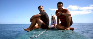 Sitting atop their capsized yacht, Matt and Kate weigh their options, while Luke checks his watch.