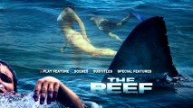 Swimmers swim past a shark fin and the distressed cover man on the DVD's main menu.