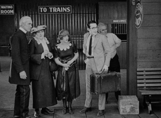 Next stop: Los Angeles. Harold Lloyd awaits the train to take him to the big city in "Safety Last!"