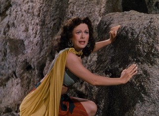 Delilah (Hedy Lamarr) watches excitedly as Samson wrestles a lion with his bare hands.