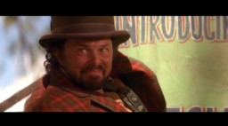 This deleted scene features Curtis Armstrong as circus showman Bulldog Drummond, a character mentioned only by sign in the final film.