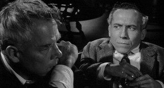 Bill Tenny (Lee Marvin) declares Karl Glocken (Michael Dunn) a "sawed-off intellectual" after the dwarf puts the alcoholic's curveball difficulties in perspective.