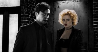 The full-color Marcie (Julia Garner) accompanies Johnny (Joseph Gordon-Levitt) to his backroom poker game.
