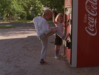 Kids find a way to kick free soda cans out of this Coca-Cola vending machine which they proceed to sell at half-price.