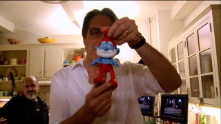 Director Raja Gosnell shows off his poseable Papa Smurf placeholder used in filming in "Comic Book to the Big Screen."