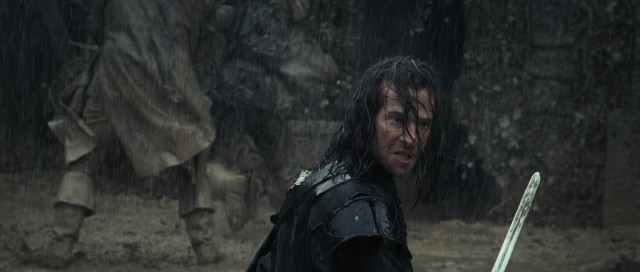 Solomon Kane (James Purefoy) swings his sword in a rainy slow-motion sequence in the sword and sorcery flick bearing his name.