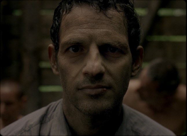 Saul Auslnder (Gza Rhrig) gives a haunting smile to a passing boy near the end of "Son of Saul."