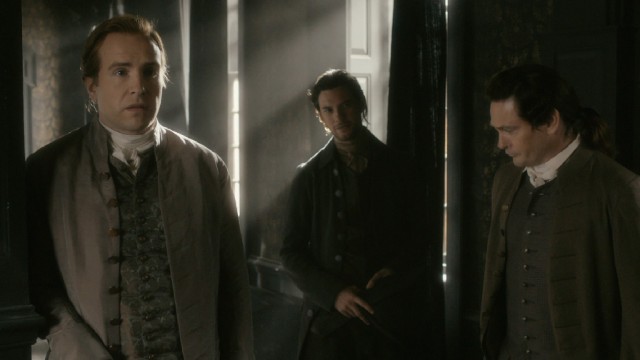 John Hancock (Rafe Spall), Sam Adams (Ben Barnes), and John Adams (Henry Thomas) catch Benjamin Franklin with a woman.