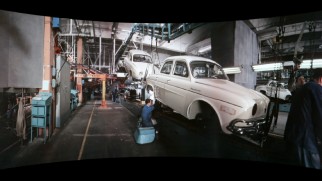 Workers assemble and test cars in the Cinerama short "Renault Dauphine."