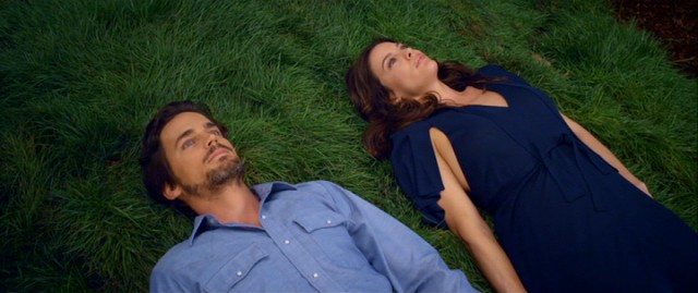 Fast friends Ted (Matt Bomer) and Lt. Commander Jessica Marlowe (Liv Tyler) share a lie-down on the grass of the space station's garden.