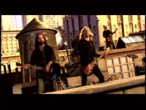 Chad Kroeger and Josey Scott perform the end credits theme "Hero" on a rooftop.