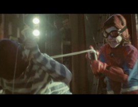 Child Spider-Man webs (silly strings) a bad guy in Snow Patrol's fun "Signal Fire" music video.