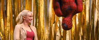 Spider-Man makes an upside-down appearance at a rally next to Gwen Stacy (Bryce Dallas Howard).