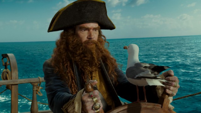 Antonio Banderas dons a thick wig and beard to play Burger Beard, the film's live-action storyteller/villain pirate/food truck owner.