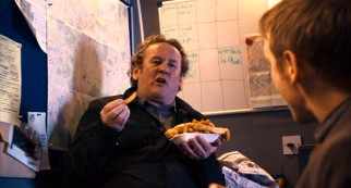Detective Inspector Weller (Colm Meaney) takes a moment from supervising the police's post to lavish praise upon fish and chips.