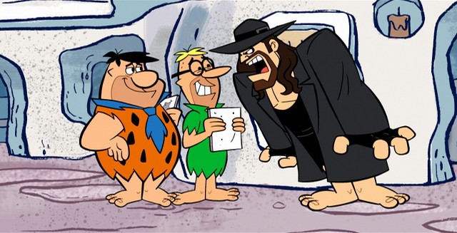 The Undertaker uses his outdoor voice on Fred Flintstone in "The Flintstones and WWE: Stone Age Smackdown."