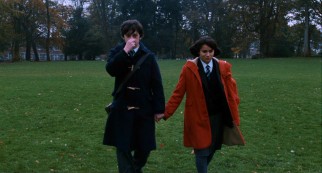 Oliver (Craig Roberts) and Jordana (Yasmin Paige) hold hands (and a nose) in a walk outside their school.
